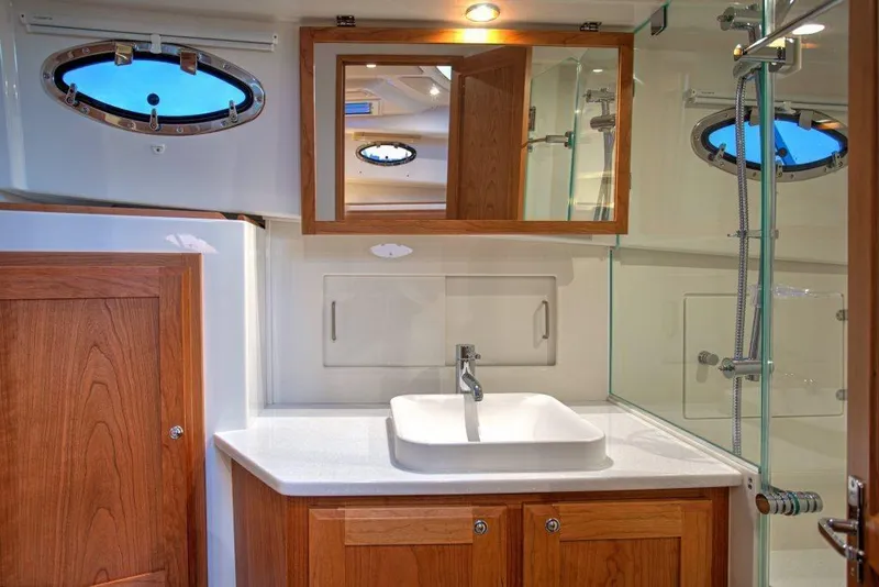 Slide: The Image of Luxurious bathroom in 2027 Back Cove 39O yacht with modern fixtures and wooden cabinetry. - 15