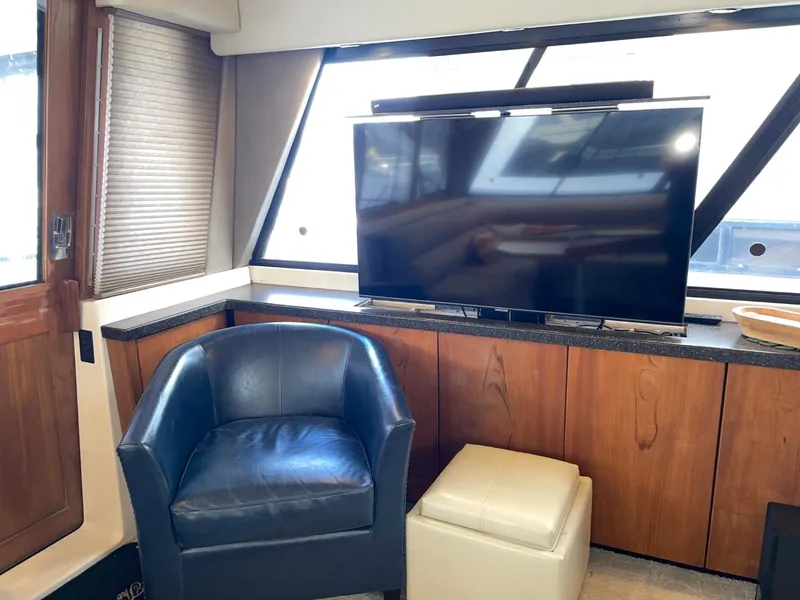 Slide: The Image of Interior of 1994 Bayliner 4788 Pilot House Motoryacht with TV, leather chair, and ottoman. - 10