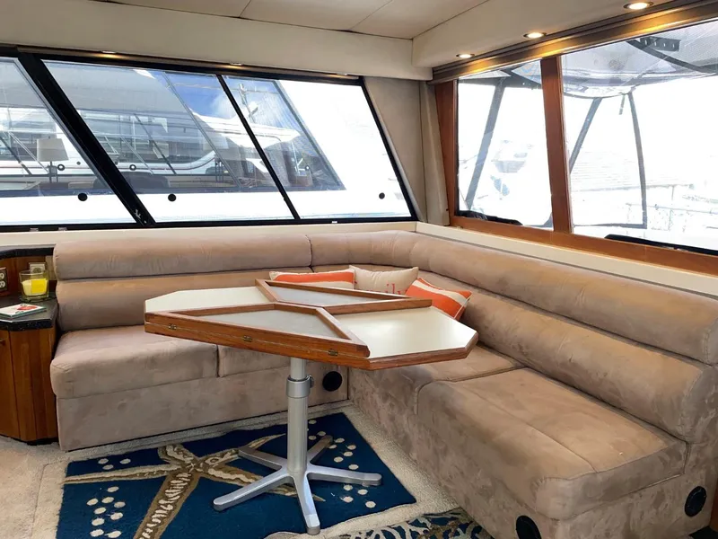 Slide: The Image of 1994 Bayliner 4788 Pilot House Motoryacht interior with beige seating and hexagonal table. - 11