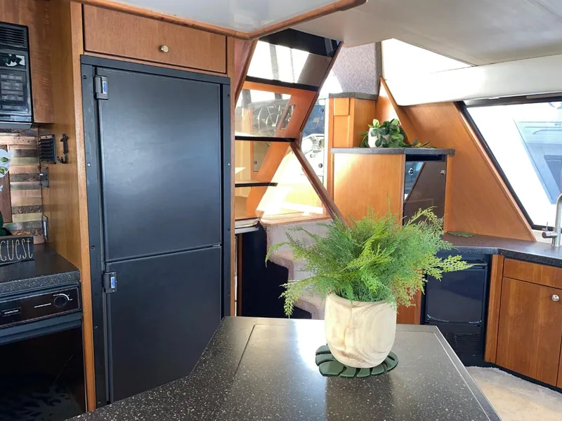 Slide: The Image of Interior of 1994 Bayliner 4788 Pilot House Motoryacht with modern kitchen and decor. - 13