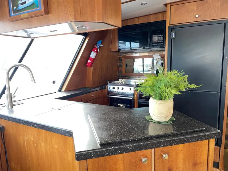Slide: The Image of Luxurious kitchen interior of 1994 Bayliner 4788 Pilot House Motoryacht with modern amenities. - 15