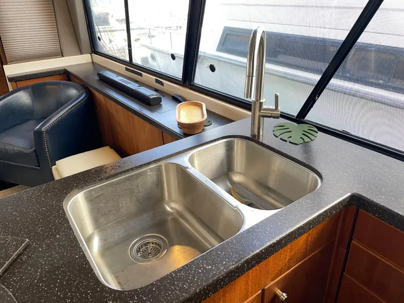 Slide: The Image of 1994 Bayliner 4788 Pilot House Motoryacht kitchen with dual sinks and modern faucet. - 21