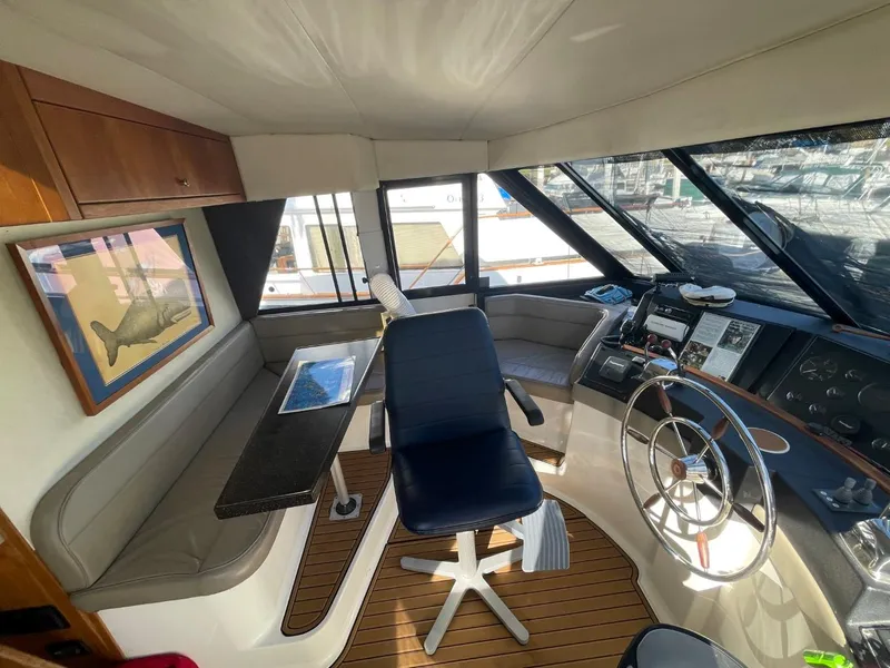 Slide: The Image of 1994 Bayliner 4788 Pilot House Motoryacht interior with helm, seating, and navigation equipment. - 29