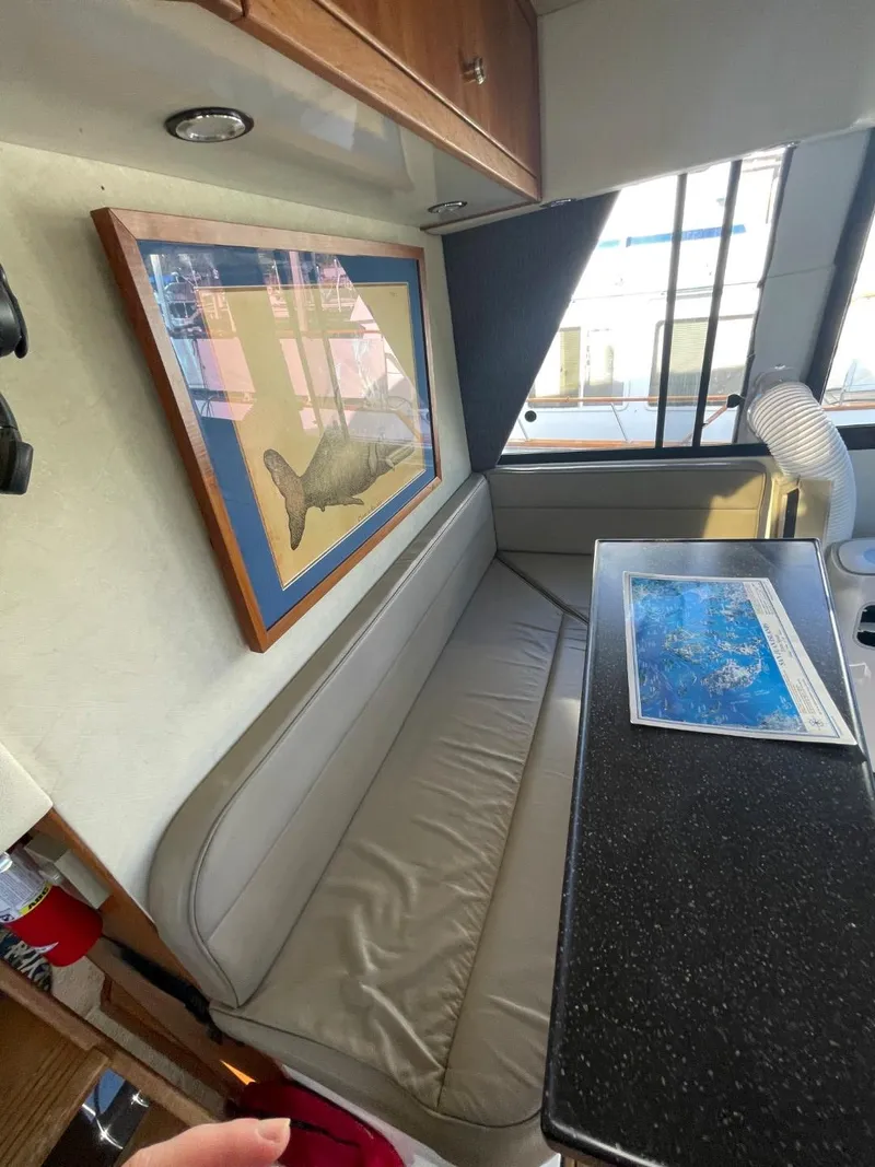 Slide: The Image of Interior of 1994 Bayliner 4788 Pilot House Motoryacht with seating, artwork, and table. - 38