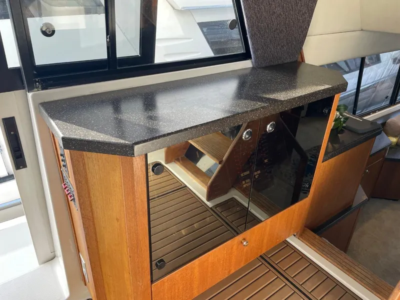 Slide: The Image of 1994 Bayliner 4788 Pilot House Motoryacht interior with sleek countertop and wooden cabinetry. - 39