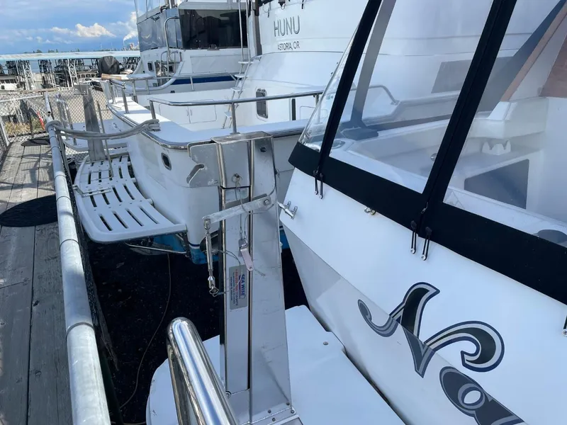 Slide: The Image of 1994 Bayliner 4788 Pilot House Motoryacht docked, showcasing sleek design and spacious deck. - 4