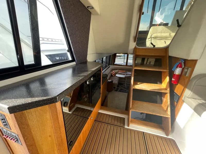Slide: The Image of 1994 Bayliner 4788 Pilot House Motoryacht interior with wooden cabinetry and stairs. - 43