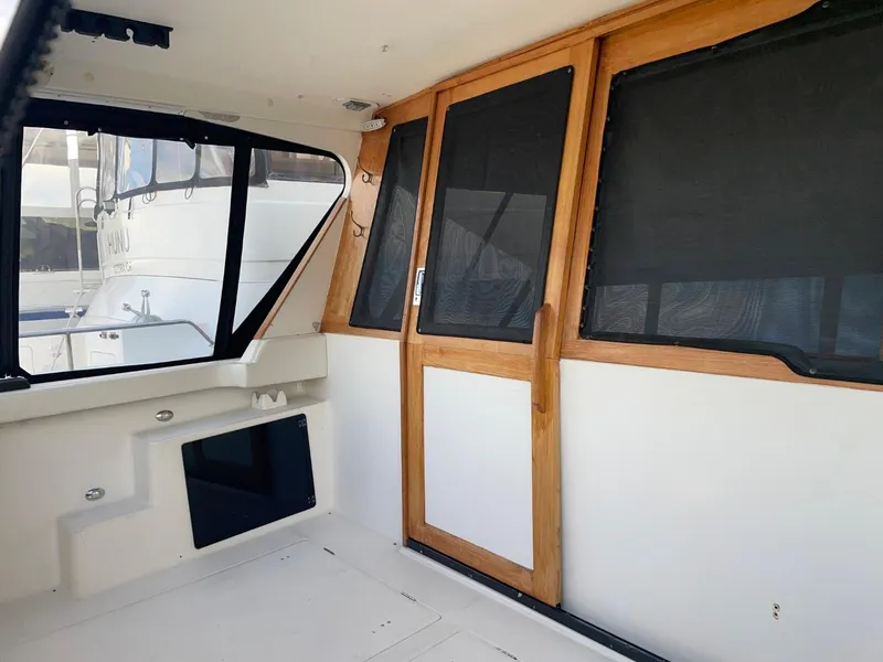 Slide: The Image of 1994 Bayliner 4788 Pilot House Motoryacht interior with wooden door and windows. - 5
