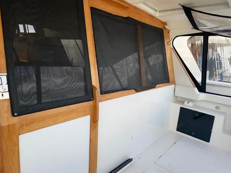 Slide: The Image of Interior view of 1994 Bayliner 4788 Pilot House Motoryacht with wooden trim and screened windows. - 6