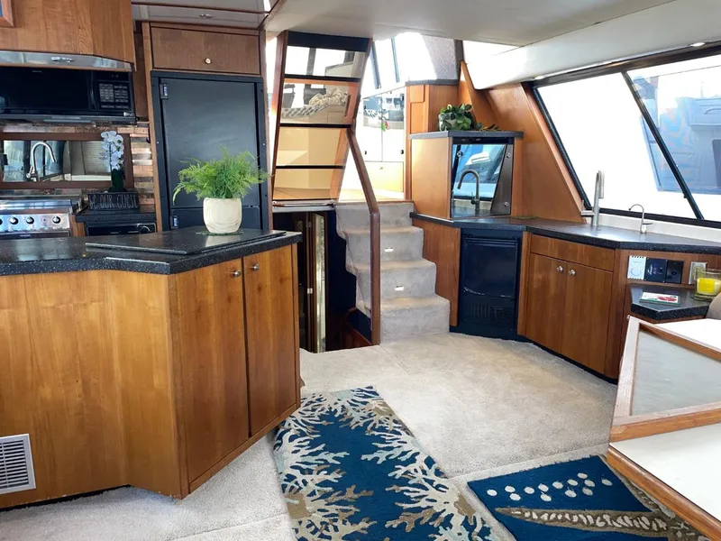 Slide: The Image of Luxurious interior of 1994 Bayliner 4788 Pilot House Motoryacht with modern kitchen and cozy seating. - 8