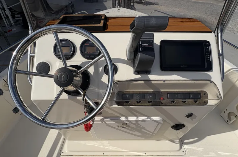Slide: The Image of Steering console of a 2005 Scout 17 boat with gauges and controls. - 7