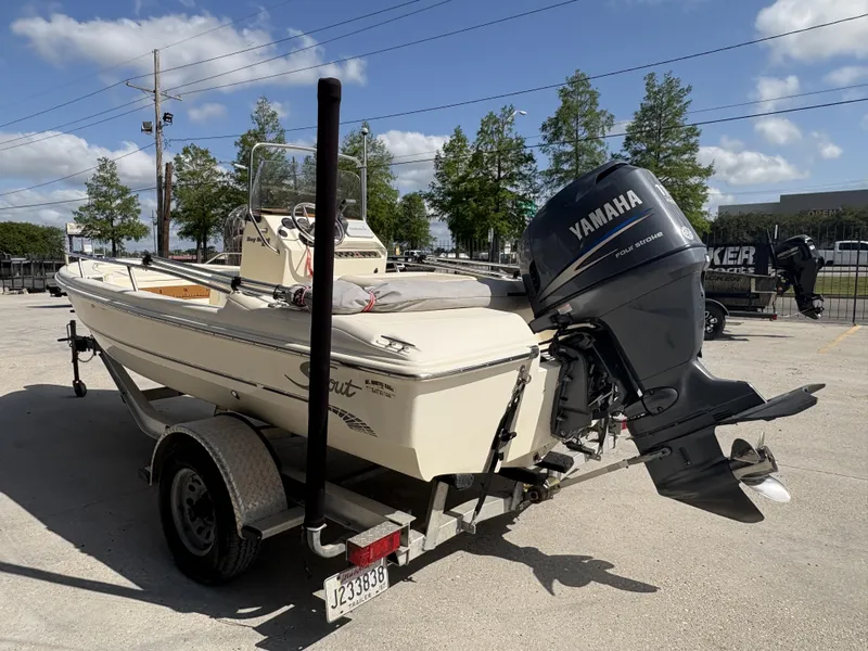 Slide: The Image of 2005 Scout 17 boat with Yamaha outboard motor on trailer, parked outdoors. - 9