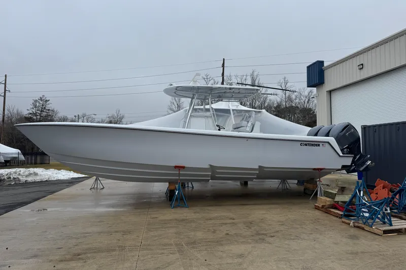 The Image of 2026 Contender 35 ST boat on stands, outdoor storage, overcast sky. - 0