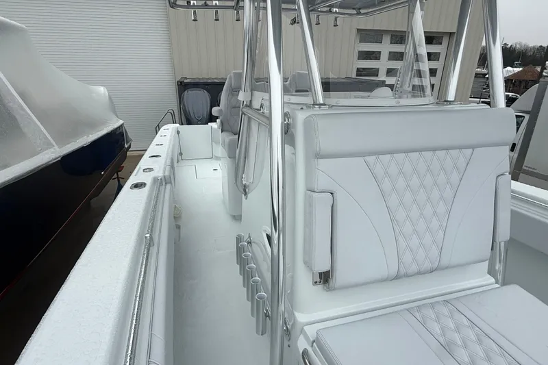 Slide: The Image of 2026 Contender 35 ST boat interior with seating and storage, docked in a marina. - 11