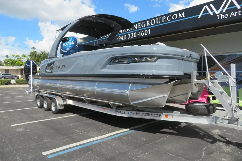 Slide: The Image of 2026 Avalon 2785 Excalibur Carbon Elite tri-toon boat on trailer, Sarasota, FL. - 1