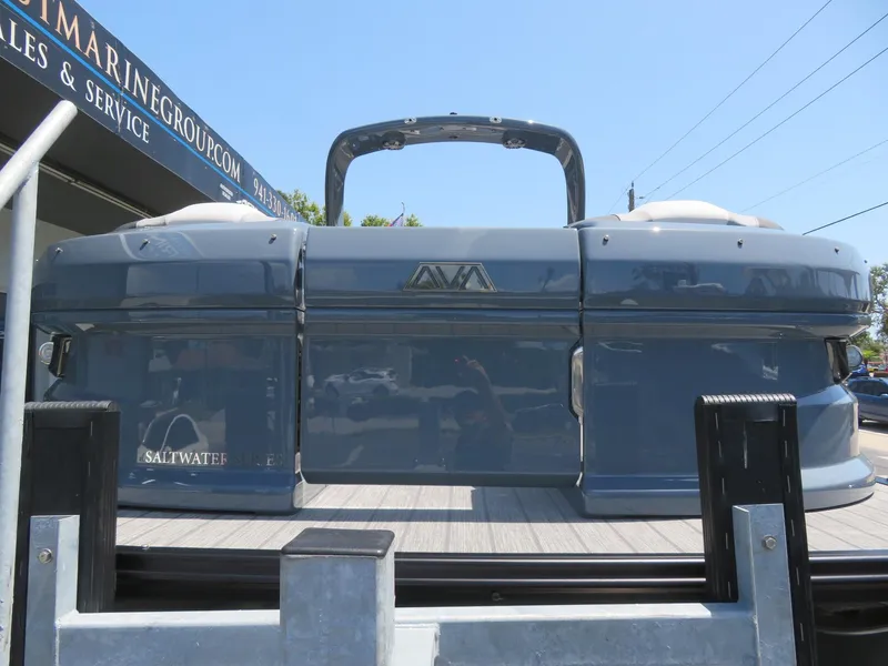 Slide: The Image of Avalon Excalibur Elite Windshield 2026 boat displayed at a marine sales and service center. - 10