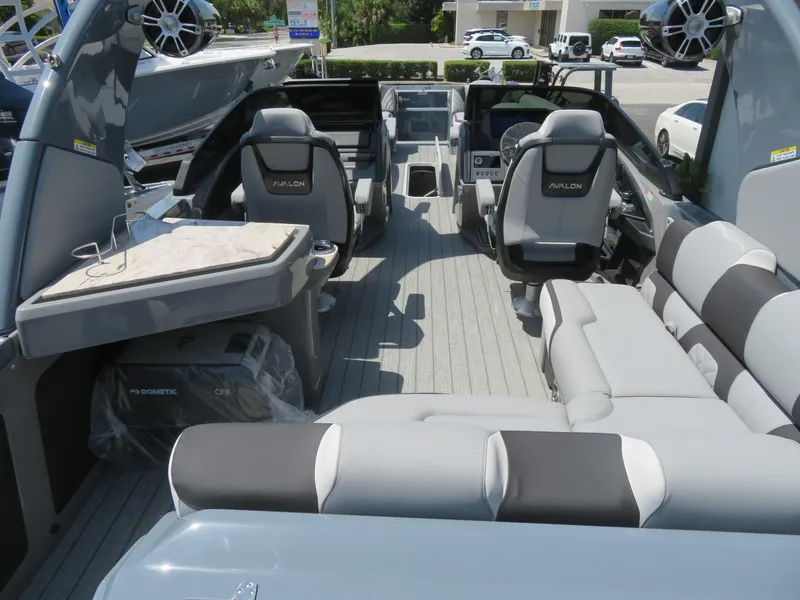Slide: The Image of Interior of 2026 Avalon Excalibur Elite Windshield boat with luxurious seating and modern design. - 16
