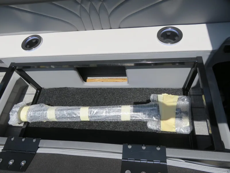 Slide: The Image of Storage compartment in Avalon Excalibur Elite Windshield 2026, featuring wrapped item and cup holders. - 25