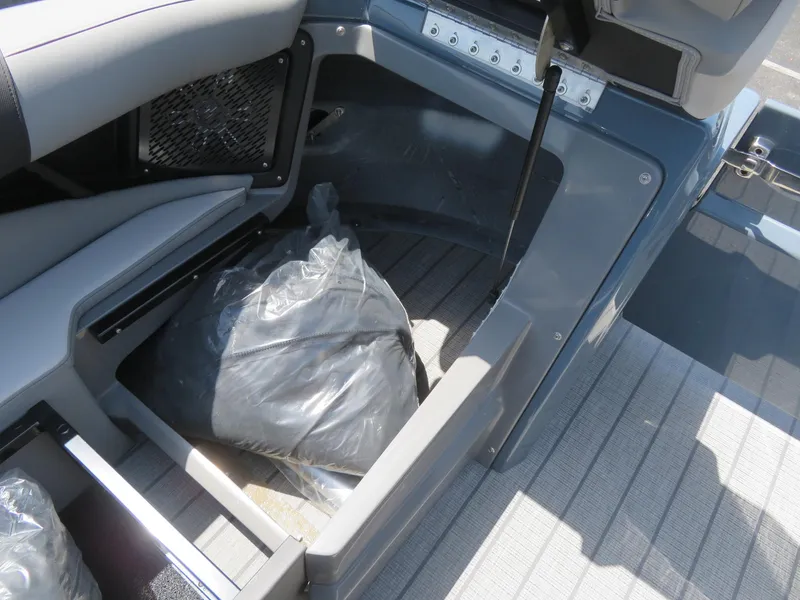 Slide: The Image of 2026 Avalon Excalibur Elite Windshield boat storage compartment with protective covers. - 30