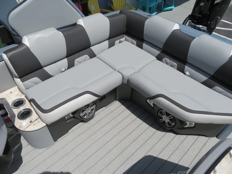 Slide: The Image of Luxurious seating in 2026 Avalon Excalibur Elite Windshield boat, featuring cup holders and speakers. - 35