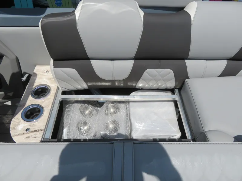 Slide: The Image of 2026 Avalon Excalibur Elite Windshield interior with storage compartment and cup holders. - 36