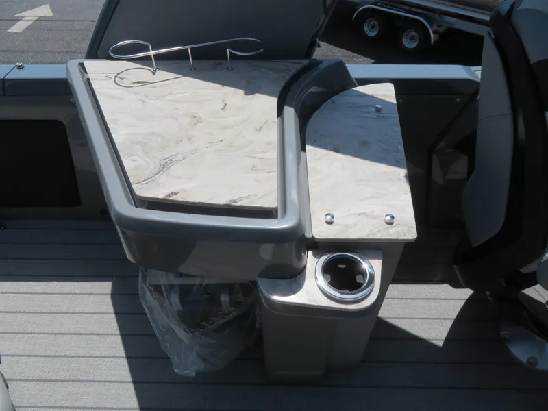Slide: The Image of Boat interior with a sleek table and cup holder, Avalon Excalibur Elite Windshield 2026 model. - 40