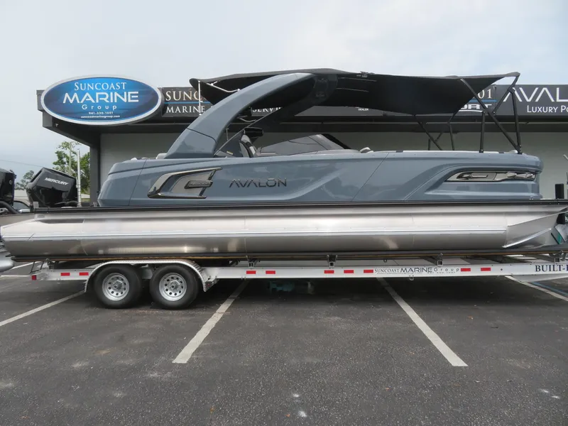 Slide: The Image of 2026 Avalon Excalibur Elite Windshield pontoon boat on trailer at Suncoast Marine Group. - 89