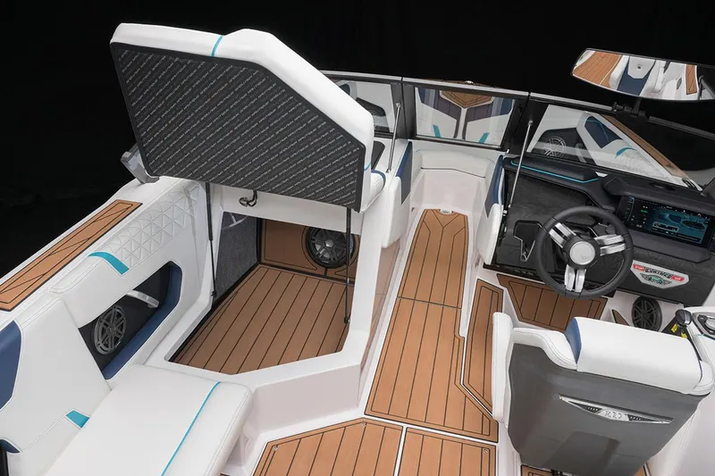 Slide: The Image of 2026 Nautique Super Air Nautique GS22 interior with storage compartment and cup holders. - 10