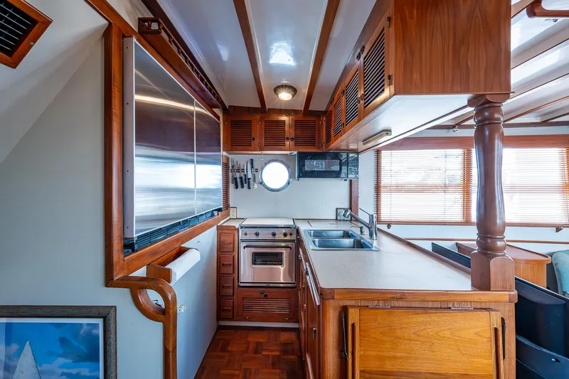 Slide: The Image of 1993 Kadey-Krogen Krogen 42 yacht interior kitchen with wood cabinetry and modern appliances. - 13