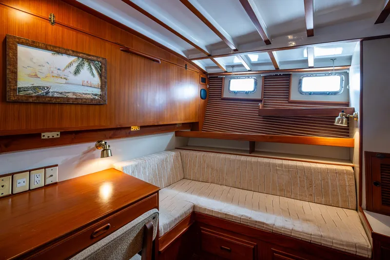 Slide: The Image of Cozy 1993 Kadey-Krogen Krogen 42 yacht interior with wood paneling and seating area. - 15