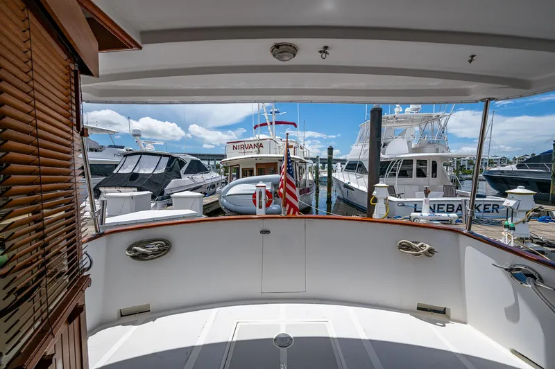 Slide: The Image of 1993 Kadey-Krogen Krogen 42 yacht docked at marina, surrounded by other boats. - 2