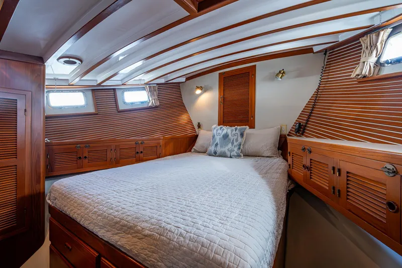 Slide: The Image of Luxurious 1993 Kadey-Krogen Krogen 42 yacht cabin with wood paneling and cozy bedding. - 21
