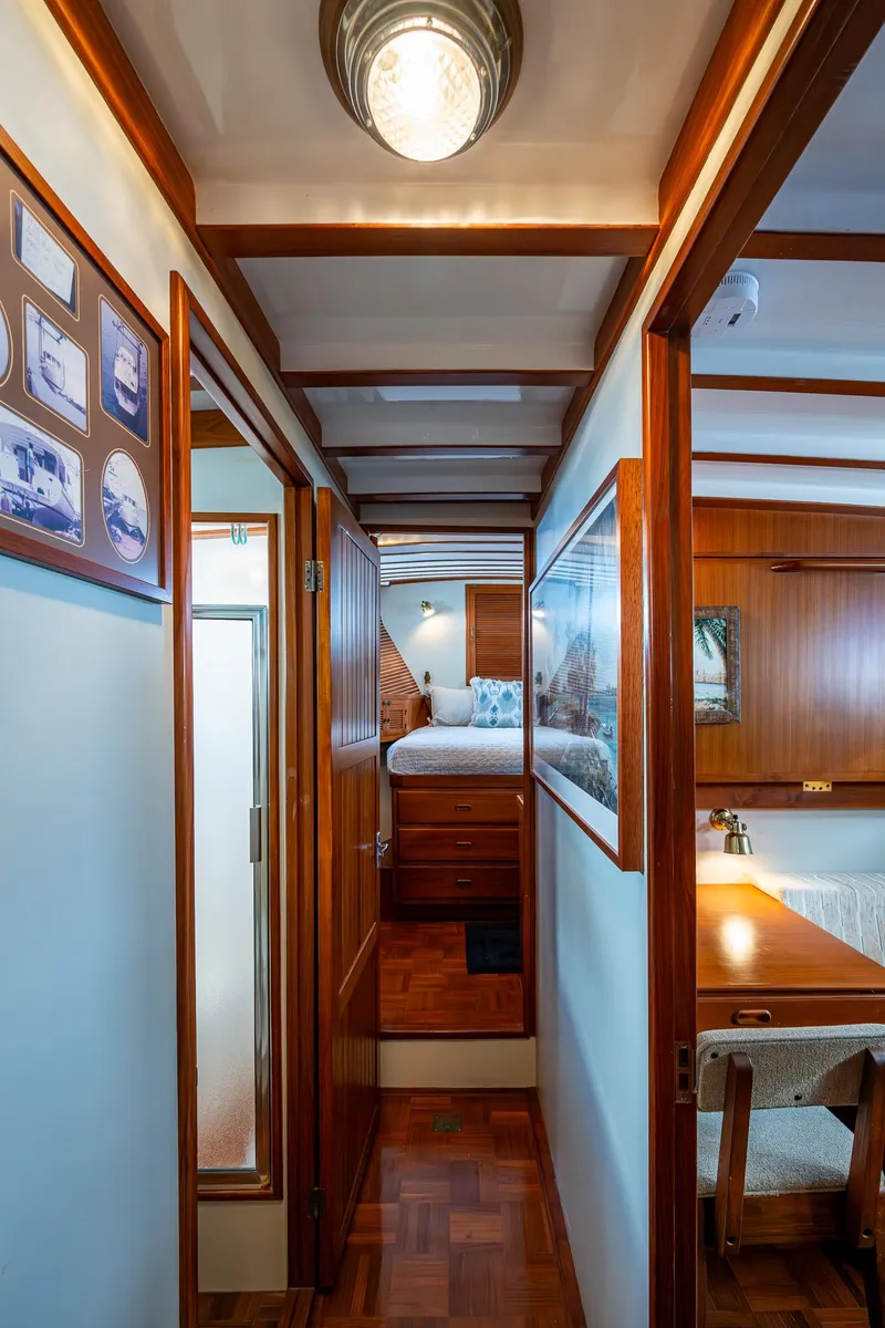 Slide: The Image of Interior of 1993 Kadey-Krogen Krogen 42 yacht, featuring wood paneling and cozy cabin space. - 28
