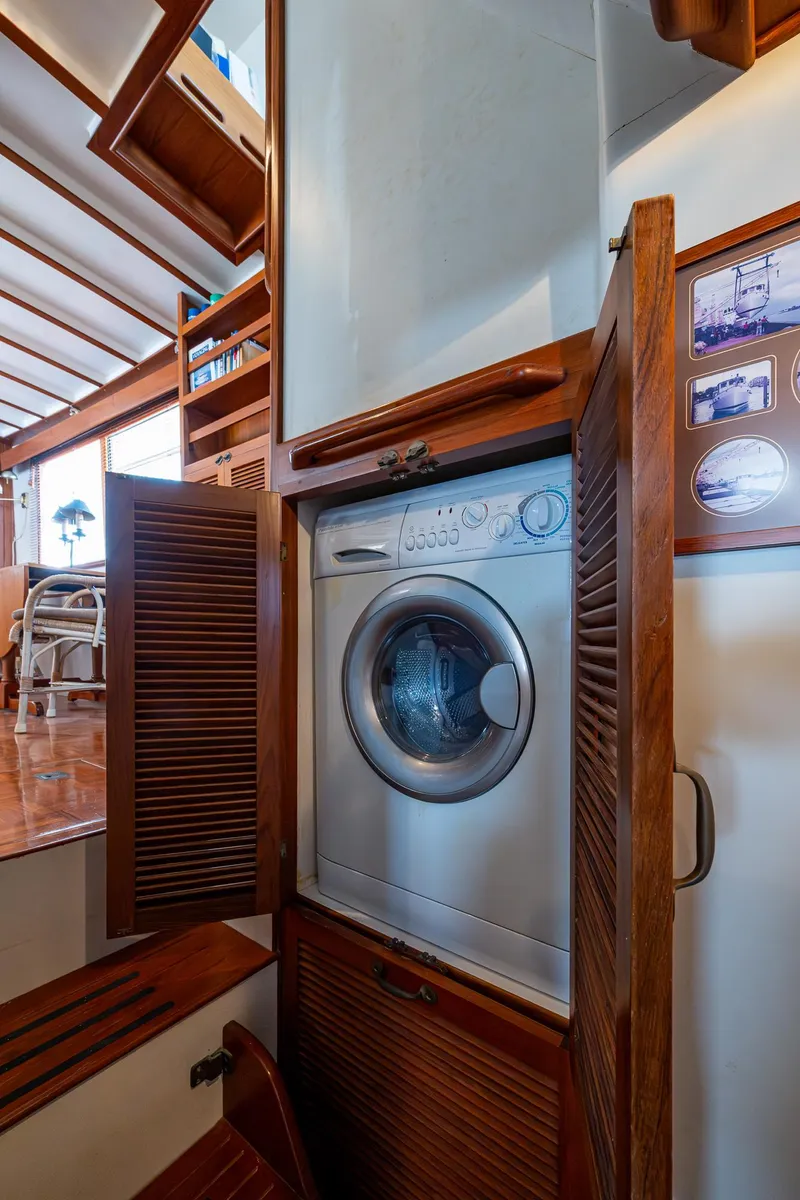 Slide: The Image of Laundry area inside 1993 Kadey-Krogen Krogen 42 yacht with wooden cabinetry. - 30