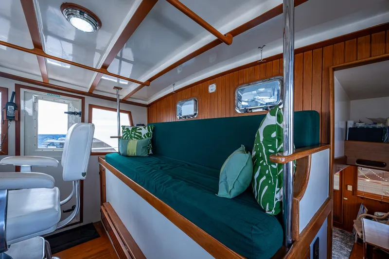 Slide: The Image of Interior of 1993 Kadey-Krogen Krogen 42 yacht with green seating and wooden accents. - 32