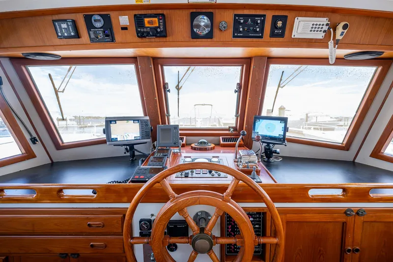 Slide: The Image of Pilothouse of 1993 Kadey-Krogen Krogen 42 with navigation equipment and wooden steering wheel. - 33