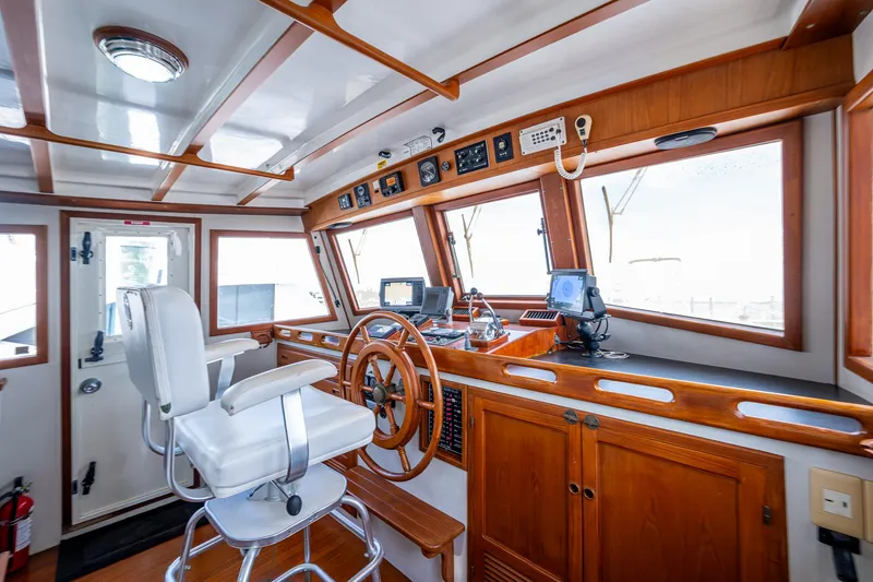 Slide: The Image of Interior of 1993 Kadey-Krogen Krogen 42 boat, featuring helm station and navigation equipment. - 34