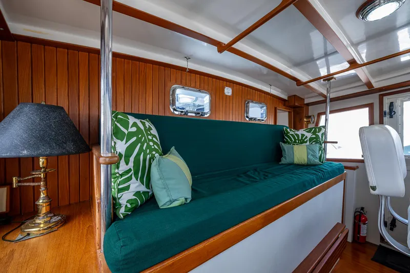 Slide: The Image of Interior of 1993 Kadey-Krogen Krogen 42 with green seating and tropical cushions. - 35