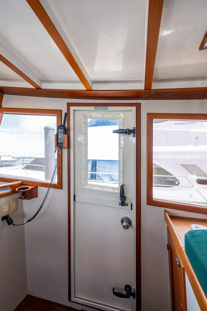 Slide: The Image of Interior of 1993 Kadey-Krogen Krogen 42 yacht, featuring a door and windows. - 36