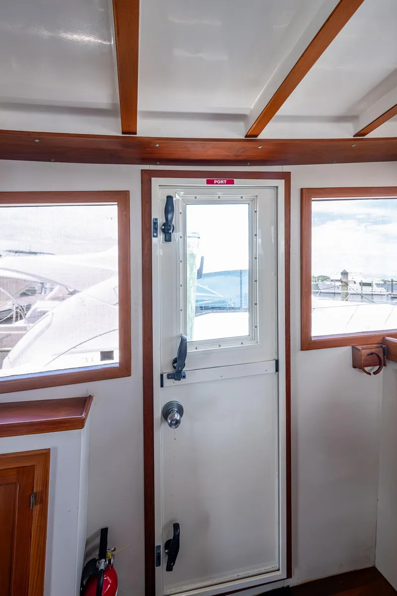 Slide: The Image of Interior view of 1993 Kadey-Krogen Krogen 42 yacht with wooden trim and door. - 37