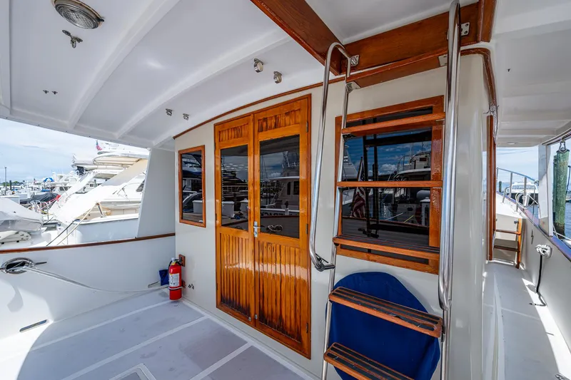 Slide: The Image of 1993 Kadey-Krogen Krogen 42 yacht deck with wooden doors and ladder. - 4