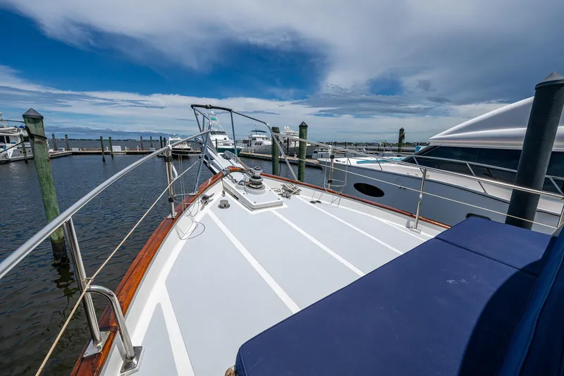 Slide: The Image of 1993 Kadey-Krogen Krogen 42 yacht deck at marina, clear sky, calm water. - 42