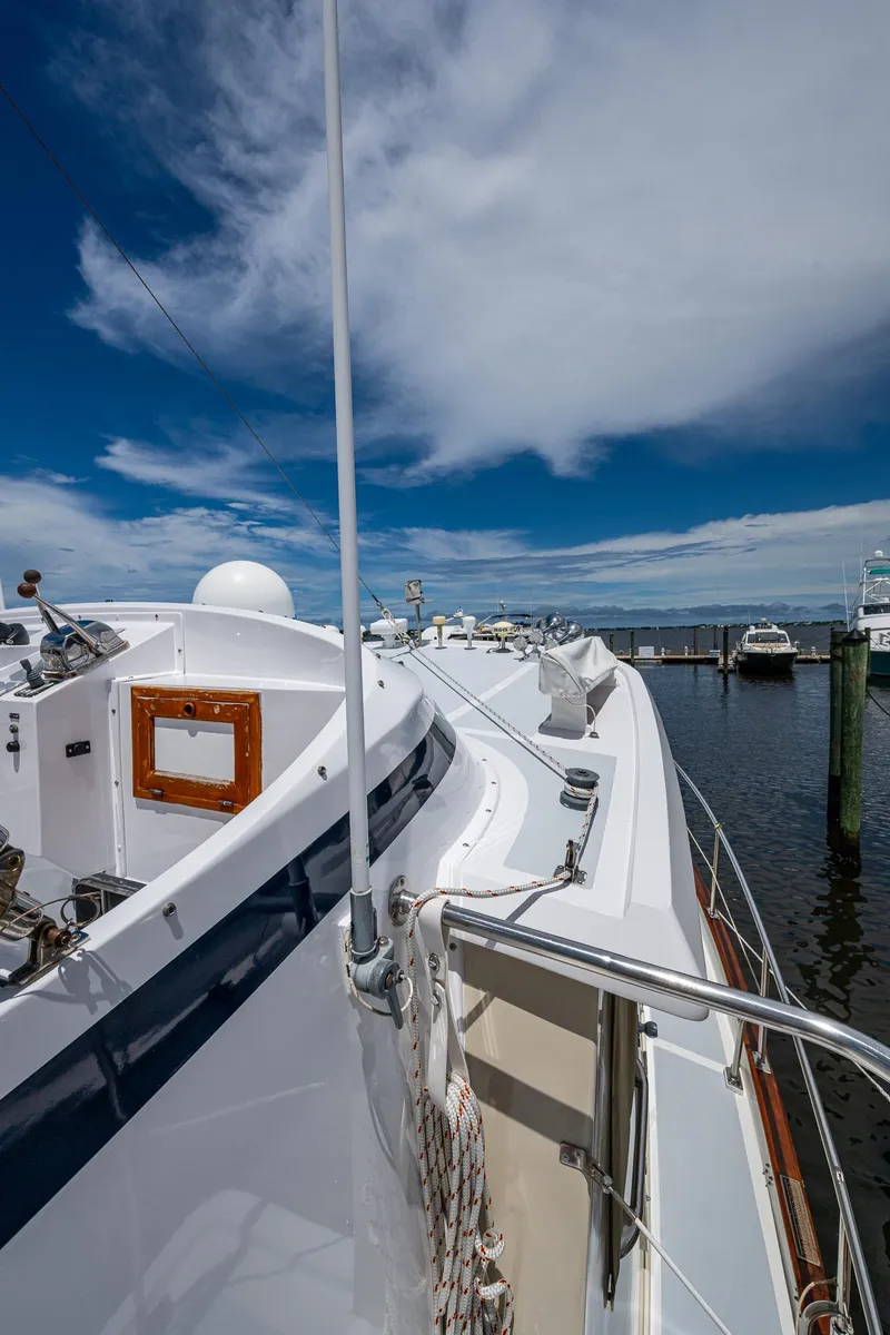Slide: The Image of Kadey-Krogen Krogen 42 yacht, 1993 model, docked under a vibrant blue sky. - 45