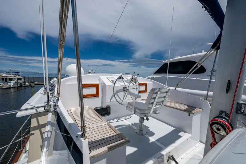 Slide: The Image of 1993 Kadey-Krogen Krogen 42 yacht helm with seating, docked under a blue sky. - 46