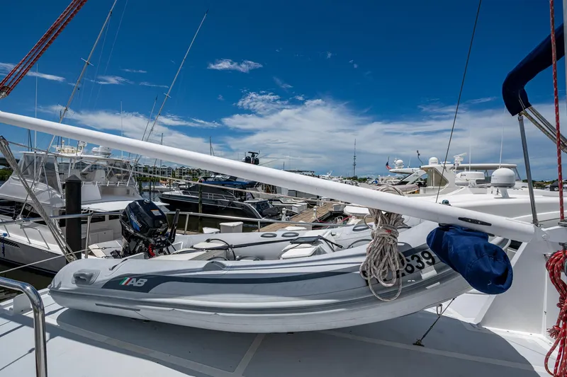 Slide: The Image of 1993 Kadey-Krogen Krogen 42 yacht with inflatable boat on deck, docked at marina. - 47