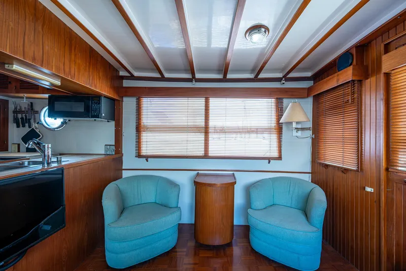 Slide: The Image of Interior of 1993 Kadey-Krogen Krogen 42 yacht with wood paneling and blue chairs. - 6