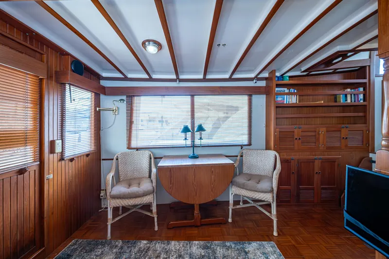 Slide: The Image of Interior of 1993 Kadey-Krogen Krogen 42 yacht with wooden decor and cozy seating area. - 7