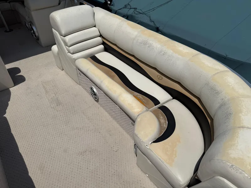 Slide: The Image of Worn seating on 2011 Tahoe Pontoon Double Decker boat, showing weathered upholstery. - 10