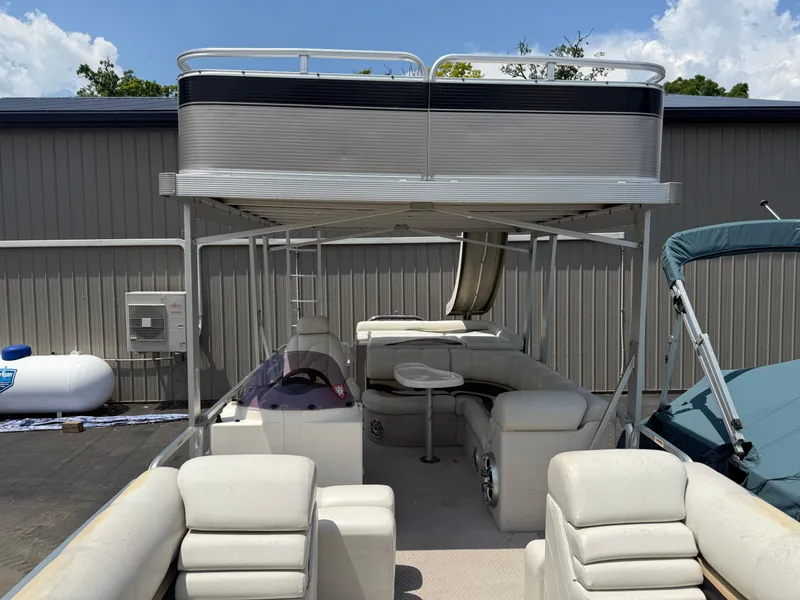 Slide: The Image of 2011 Tahoe Pontoon Double Decker boat with upper deck and slide, parked outdoors. - 12