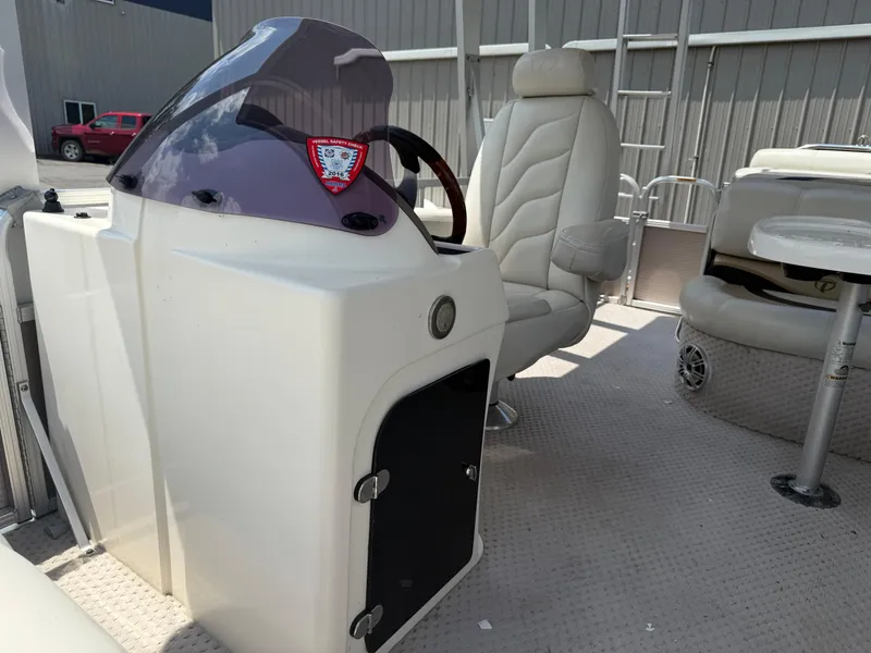 Slide: The Image of 2011 Tahoe Pontoon Double Decker interior with captain's chair and control console. - 14